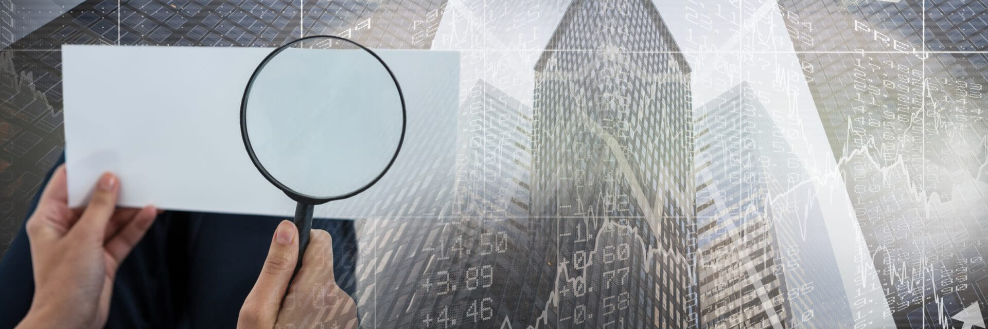 A magnifying glass inspecting a commercial building