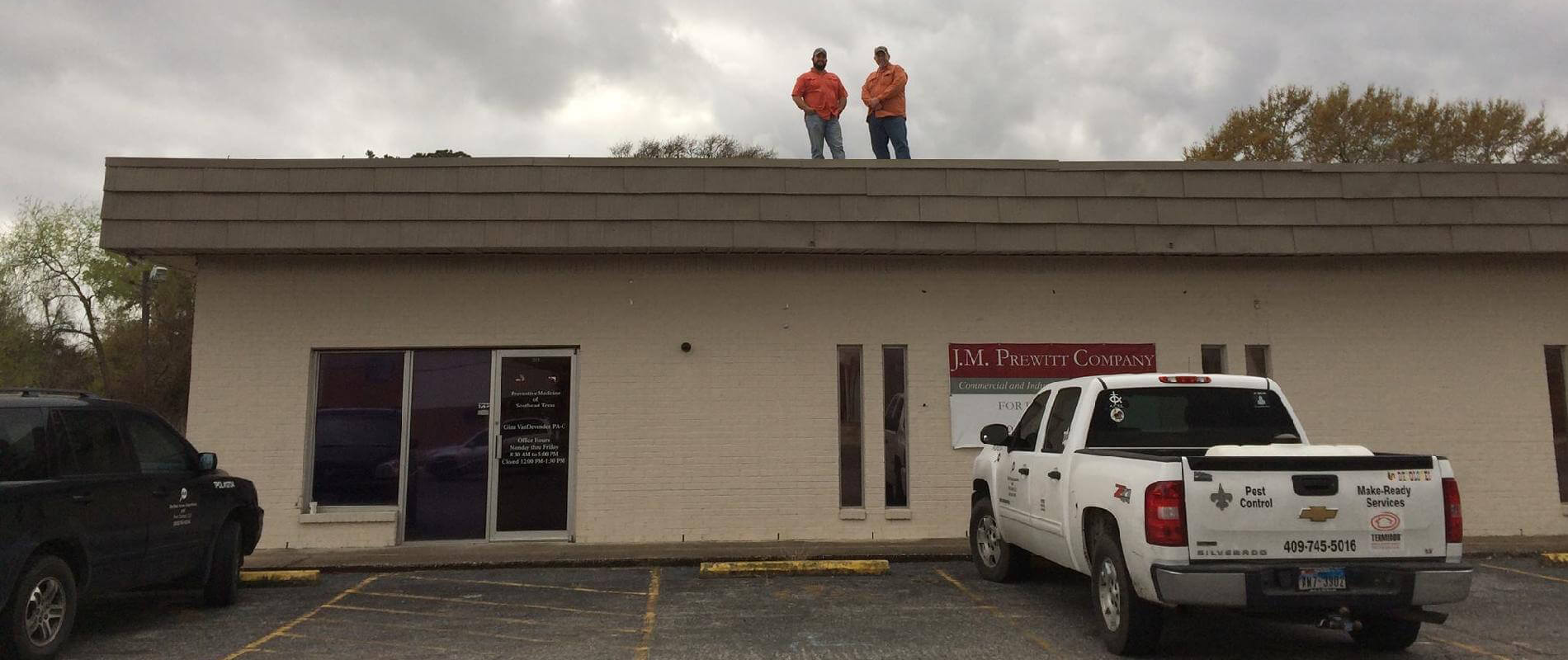 Two men standing on top of a building